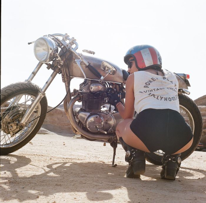 A playful frame from Girls on a motorcycle — online in Dalian